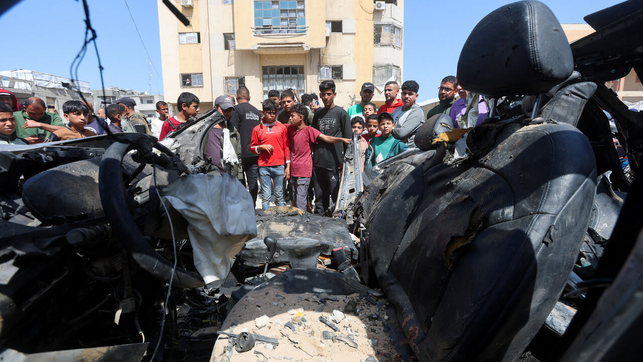 Palestinians inspect the site of an Israeli strike on a car in Khan Younis, in the southern Gaza Strip, May 10, 2026. REUTERS/Ramadan Abed