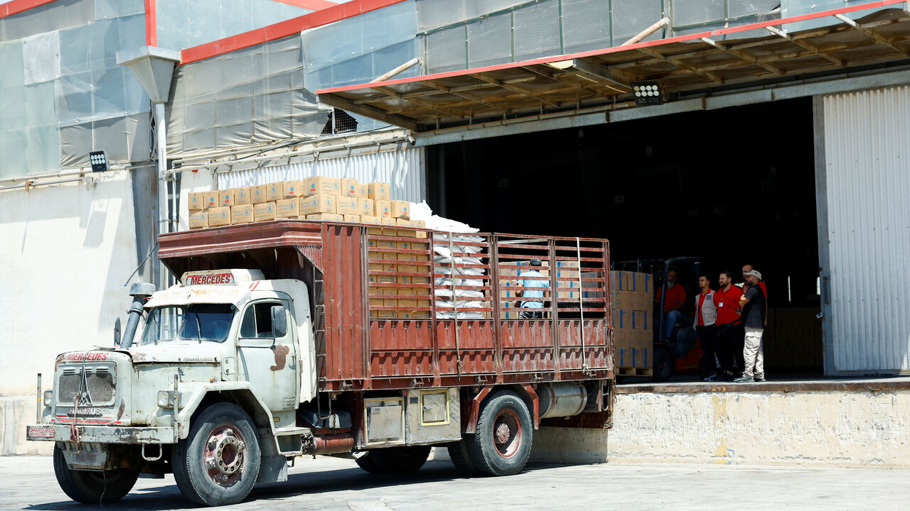 Workers load aid boxes onto a truck at a World Food Programme (WFP) facility in Damascus countryside, Syria, July 29, 2025. REUTERS/Yamam Alshaar
