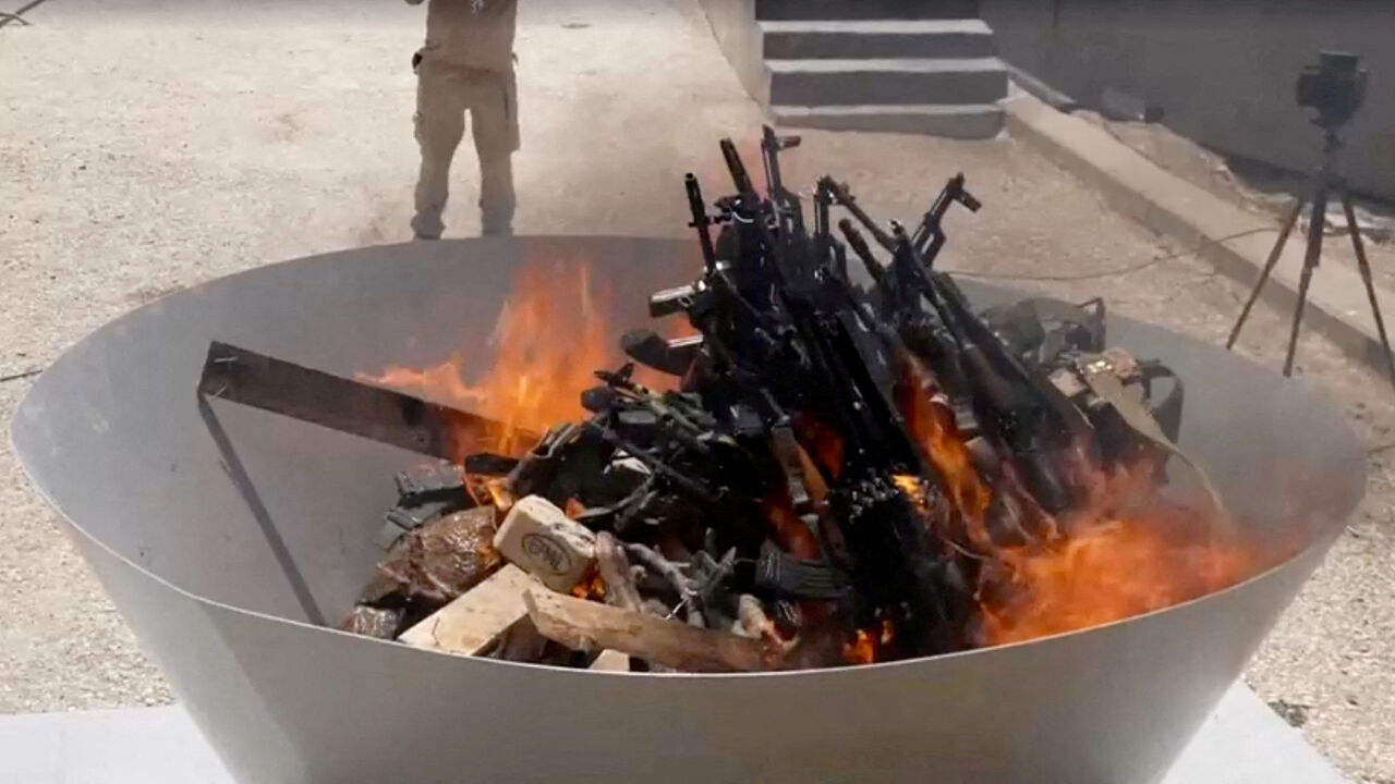 FILE PHOTO: Weapons placed by PKK fighters are burnt during a disarming ceremony in Sulaimaniya, Iraq, July 11, 2025, in this screengrab obtained from a handout video. KURDISTAN WORKERS PARTY MEDIA OFFICE/Handout via REUTERS/File Photo