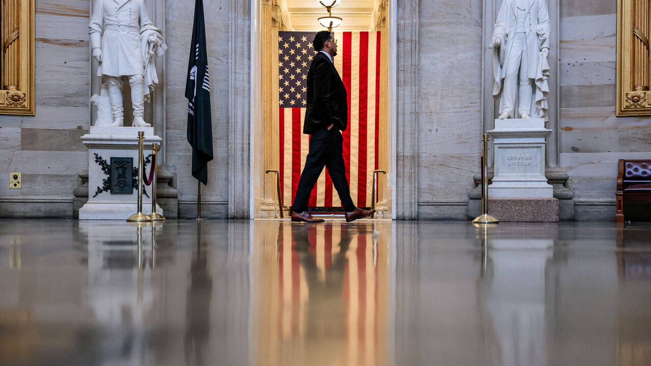 A person walks in front of an American flag in the Rotunda of the U.S. Capitol building in Washington, D.C., U.S., May 14, 2026. REUTERS/Kylie Cooper