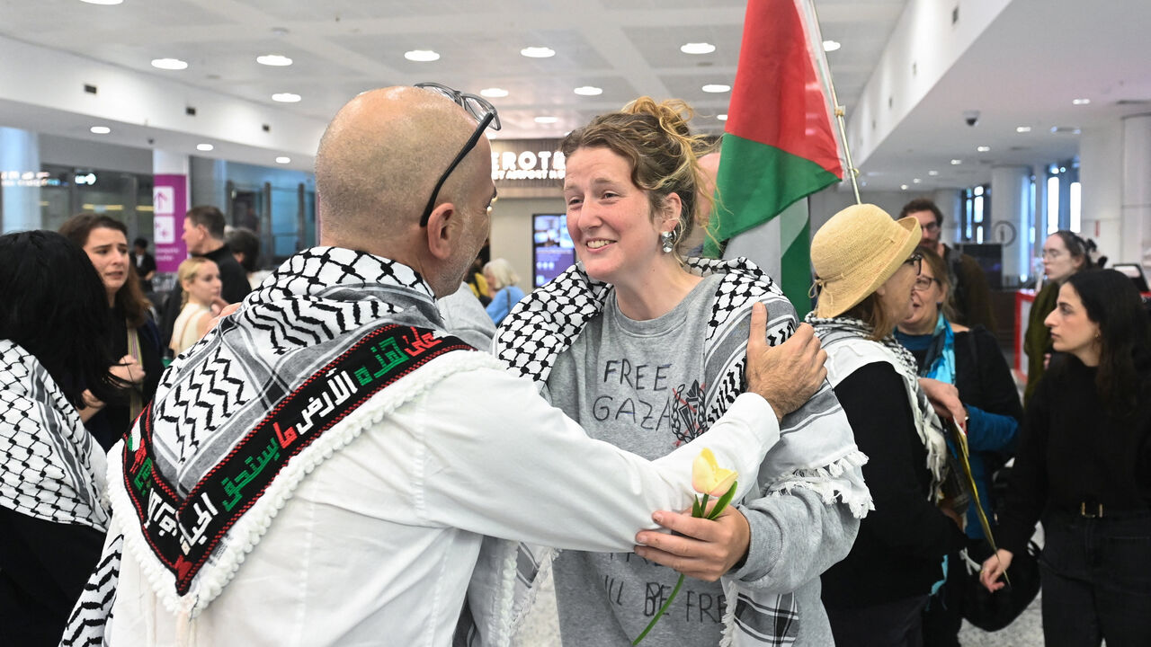 An Australian member of the Global Flotilla to Gaza receives a hug as they arrive at Sydney International Airport, Sydney, Australia, May 25, 2026. REUTERS/Jeremy Piper