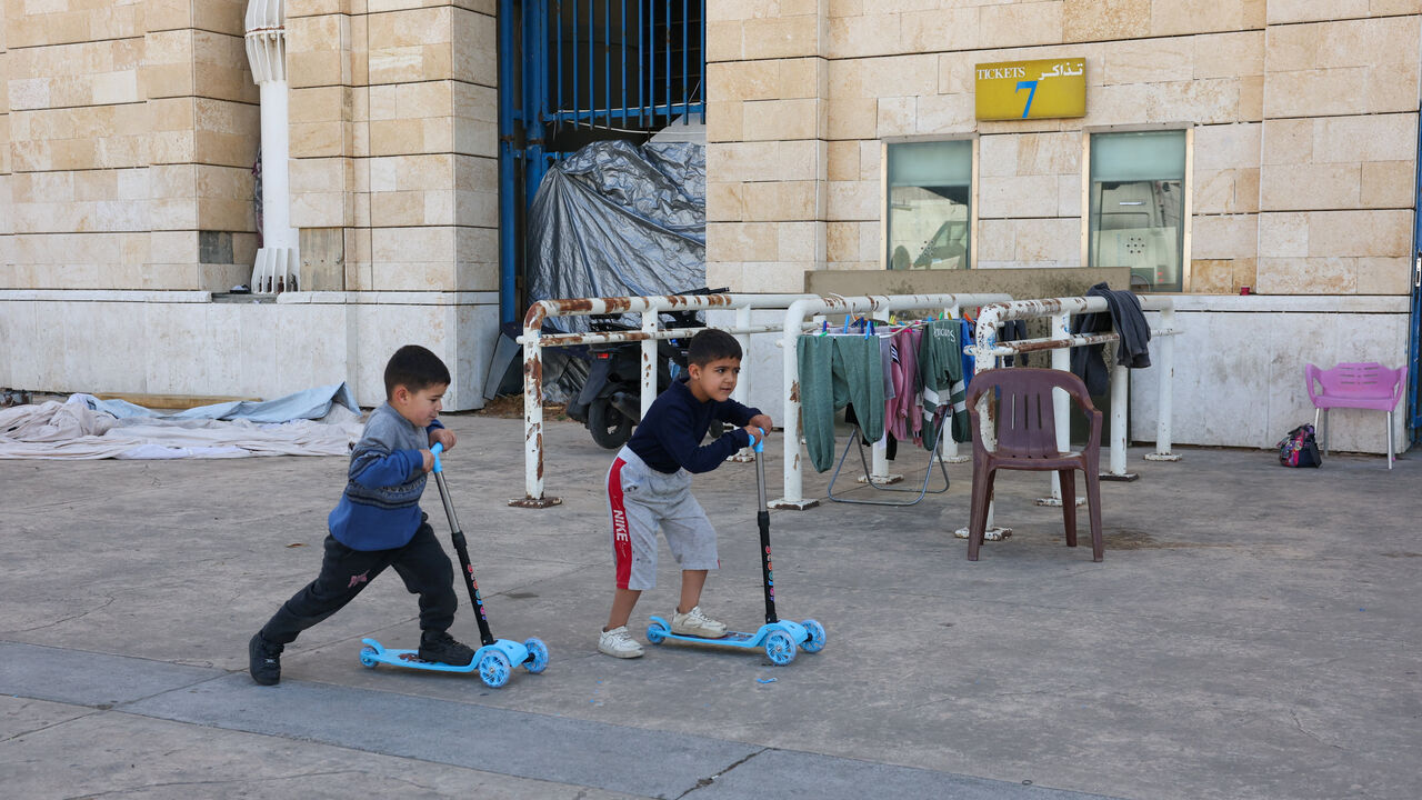 Children play outside Camille Chamoun Sports City stadium, turned into a temporary shelter in Beirut, Lebanon, May 8, 2026. REUTERS/Mohamed Azakir