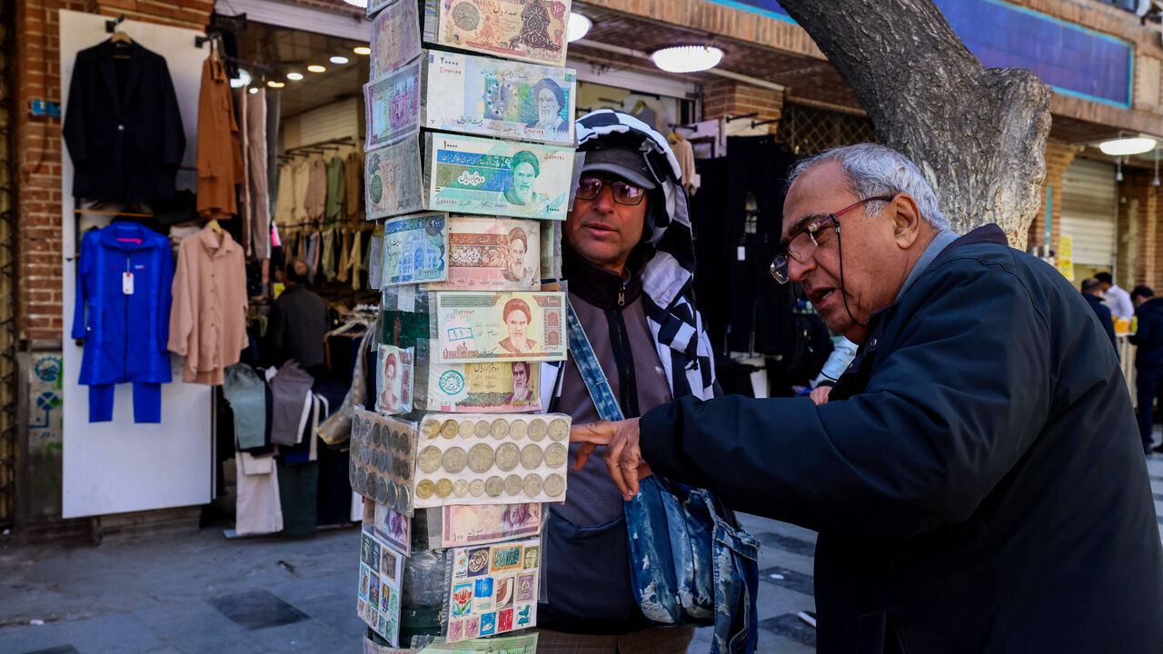 A man checks old banknotes in the Grand Bazaar in Tehran on March 3, 2025. 