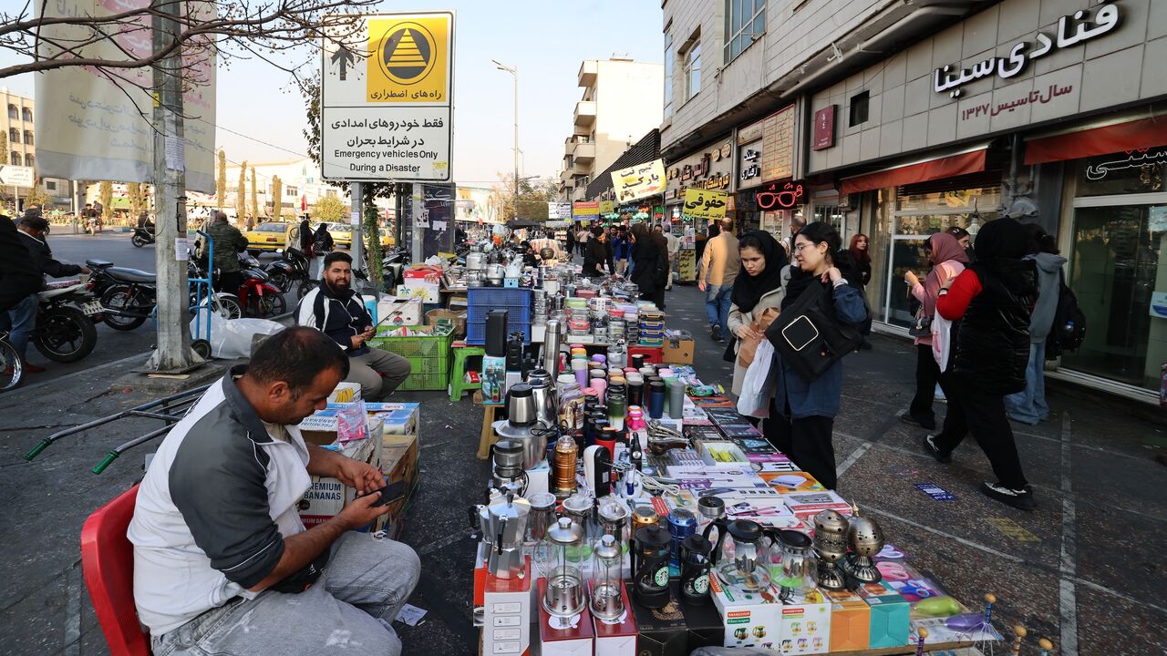 Women shop from a street vendor at Enghelab Square in the capital Tehran on Nov. 11, 2025. 