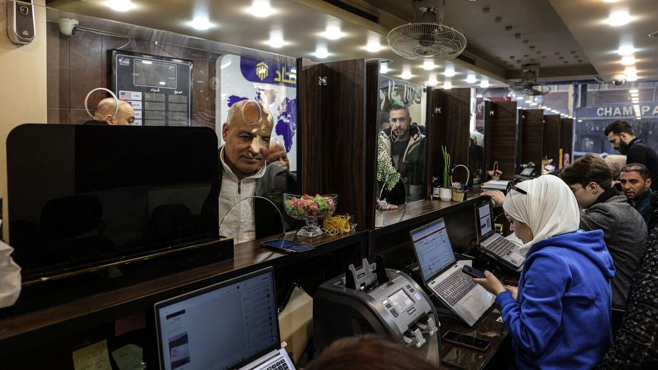 A Syrian citizen exchanges old banknotes for new notes released and distributed by the central bank, at a bank in the capital, Damascus, on Jan. 3, 2026. — Bakr ALkasem / AFP via Getty Images