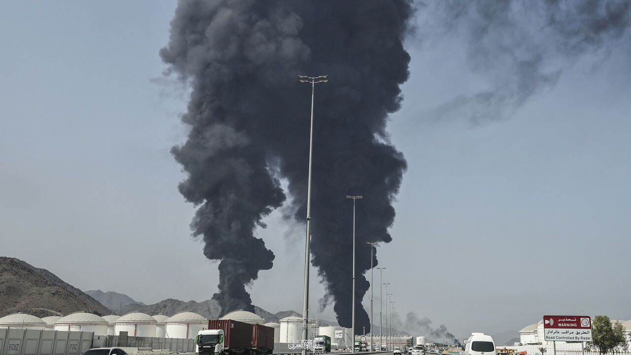 TOPSHOT - Smoke rises from the direction of an energy installation in the Gulf emirate of Fujairah on March 14, 2026. Smoke could be seen rising from the direction of a major UAE energy installation on March 14, in what appeared to be the latest strike targeting the Gulf's petroleum facilities hours after the US struck Iran's Kharg Island. (Photo by AFP via Getty Images) /
