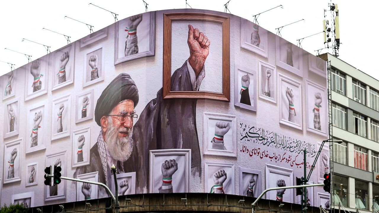 A billboard with the image of the late Iranian supreme leader Ayatollah Ali Khamenei wraps the front of a building in Tehran on May 5, 2026. 