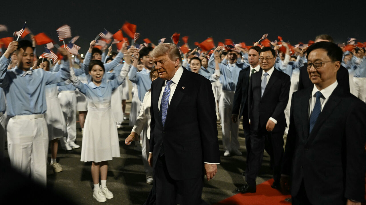 TOPSHOT - US President Donald Trump (C) is escorted by China's Vice President Han Zheng (R) upon his arrival at Beijing Capital Airport in Beijing on May 13, 2026. (Photo by Brendan SMIALOWSKI / AFP via Getty Images)