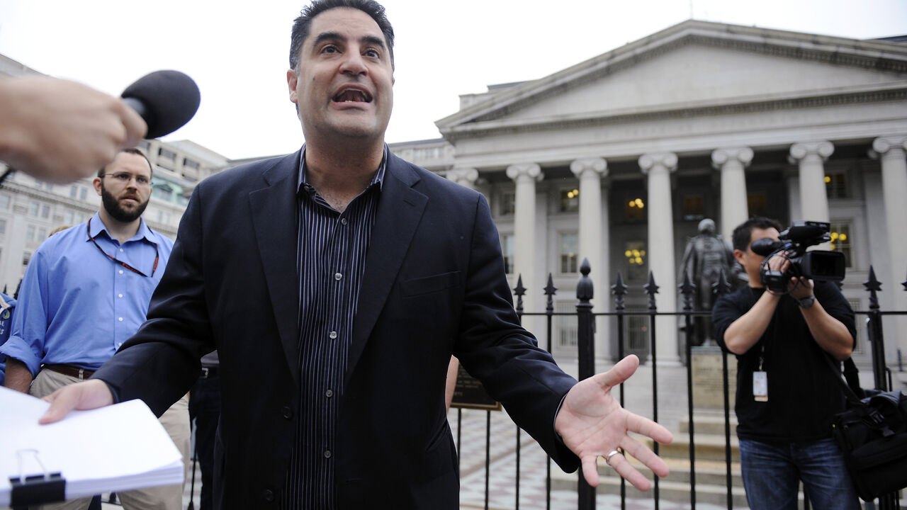 The Young Turks radio show host Cenk Uygur (C) leads a protest of government bailout money given to Goldman Sachs, with listeners gathered in front of the US Treasury building in Washington, June 9, 2010. REUTERS/Jonathan Ernst/ File Photo