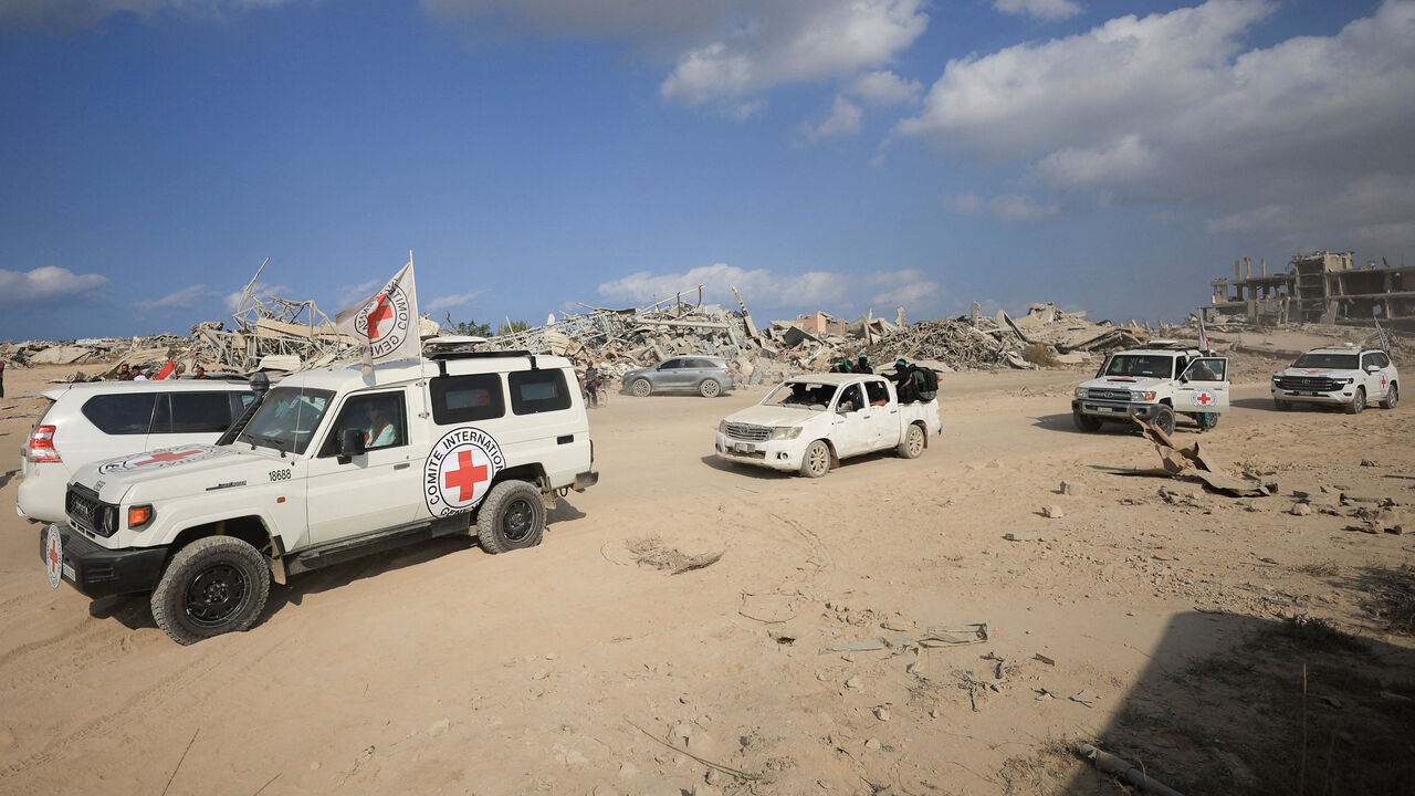 FILE PHOTO: Red Cross personnel, escorted by Hamas militants, wait to head towards an area within the so-called "yellow line" to which Israeli troops withdrew under the ceasefire, as Hamas says it continues to search for the bodies of deceased hostages seized during the October 7, 2023, attack on Israel, in Gaza City November 12, 2025. REUTERS/Dawoud Abu Alkas/File Photo