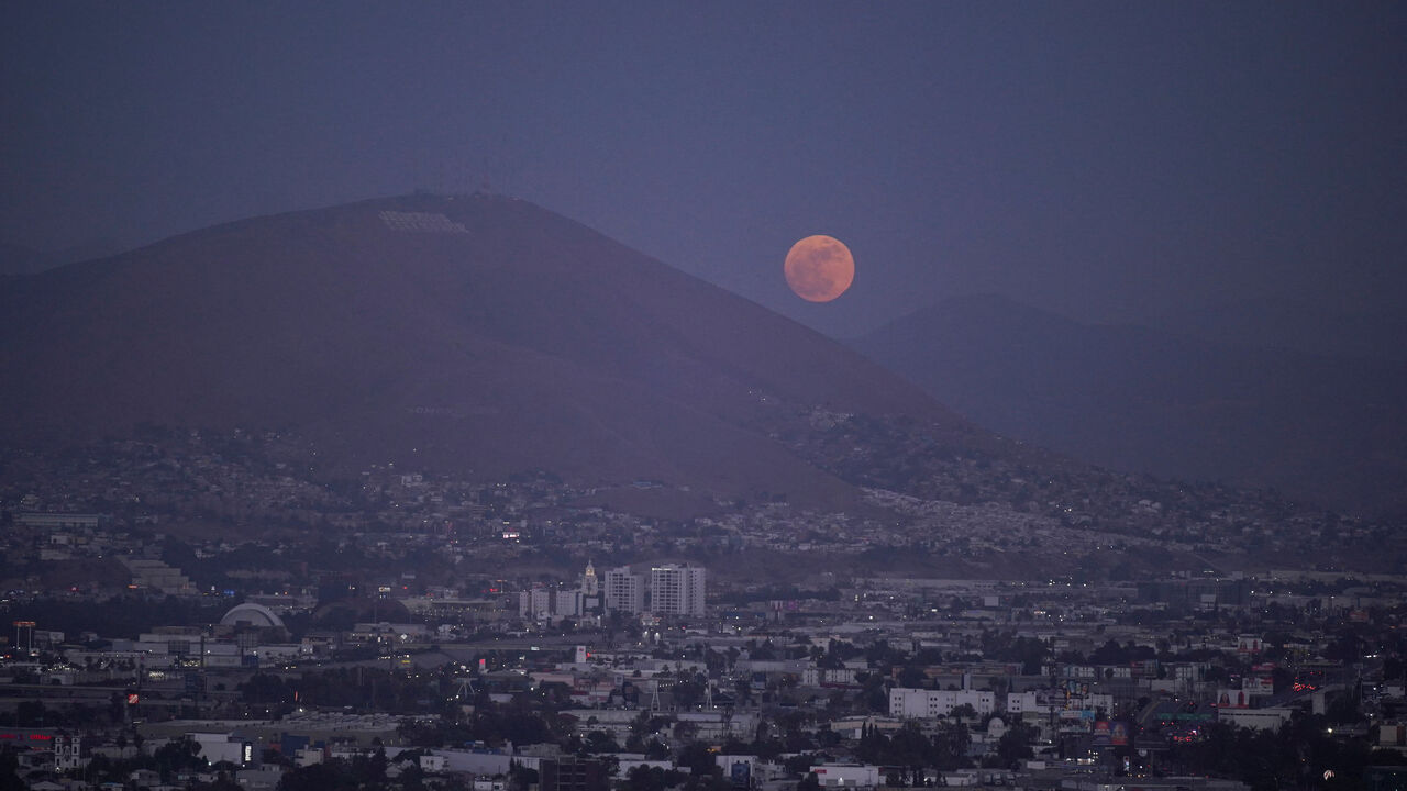 The moon rises over Tijuana as the Iranian national soccer team is set to establish its base camp for the FIFA World Cup 2026 in the Mexican border city after Mexico’s President Claudia Sheinbaum agreed to host the squad, following reports that the U.S. government did not want Iran to remain at its original base in Arizona during the tournament, in Tijuana, Mexico, May 30, 2026. REUTERS/Victor Medina