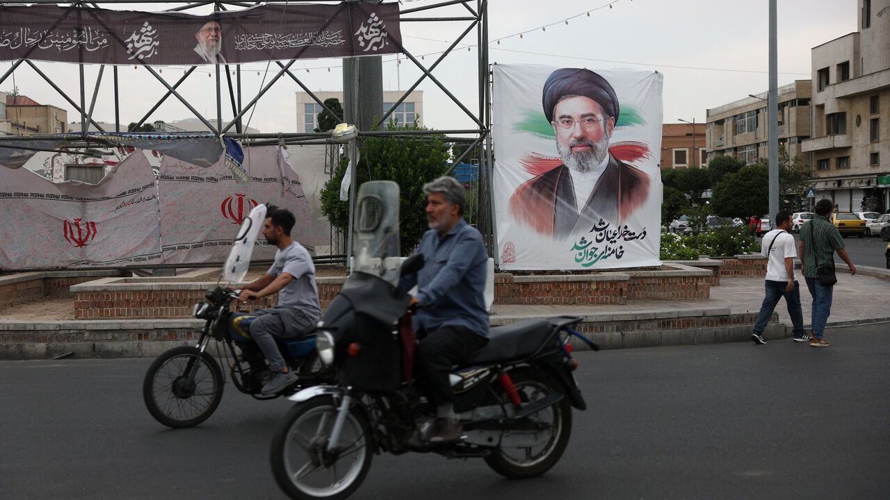 People ride near a banner with an image of Iran's Supreme Leader, Mojtaba Khamenei, on a street in Tehran, Iran June 7, 2026. Majid Asgaripour/WANA (West Asia News Agency) via REUTERS