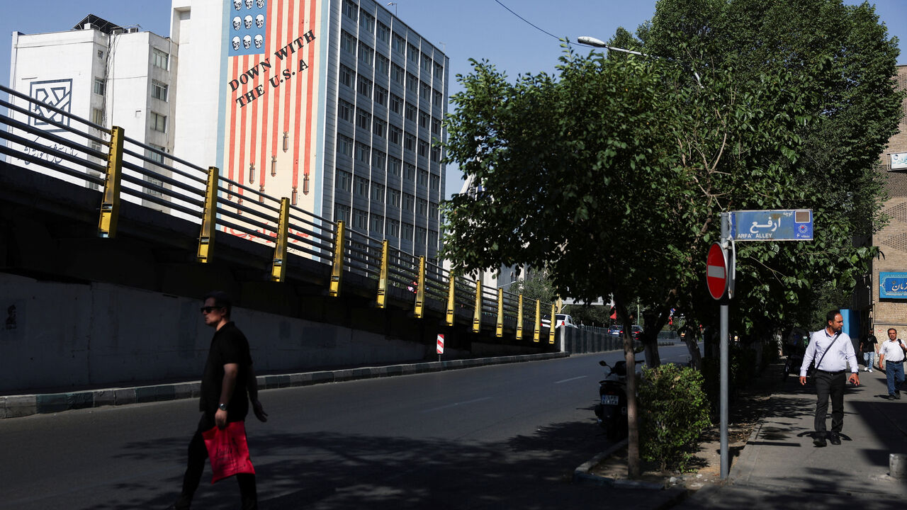 A man walks near an anti-U.S. mural on a building in Tehran, Iran, June 11, 2026. Majid Asgaripour/WANA (West Asia News Agency) via REUTERS