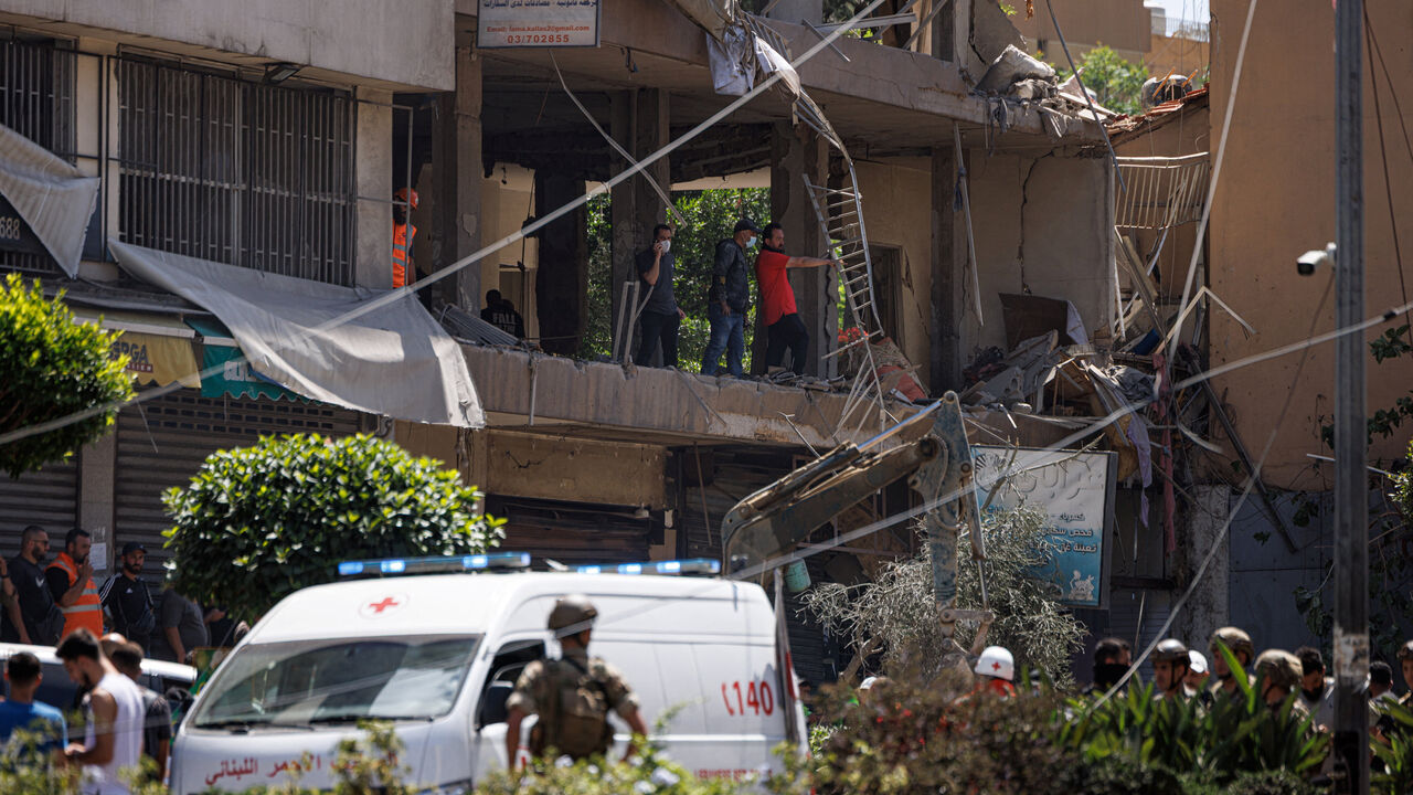 A Lebanese army officer stands as police officers and emergency personnel work at the site of an Israeli strike on the southern suburbs of Beirut, Lebanon, June 14, 2026. REUTERS/Zohra Bensemra