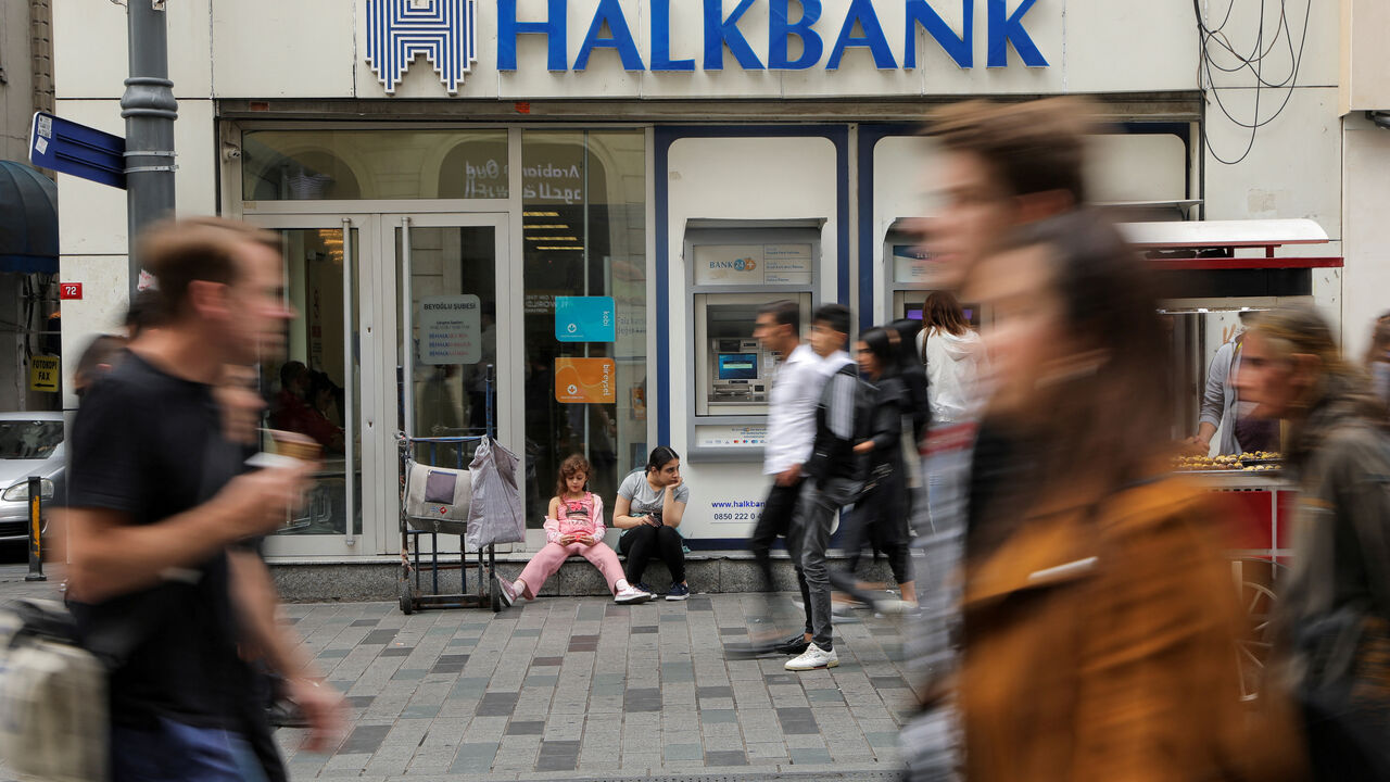 FILE PHOTO: File Photo: People walk past by a branch of Halkbank in central Istanbul, Turkey, October 16, 2019. REUTERS/Huseyin Aldemir/File Photo/File Photo