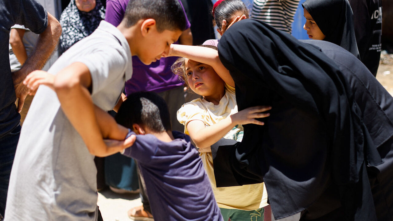 Children of Palestinian Ahmad Abu Heen attend his and his brother's Mahmoud Abu Heen's funeral, after they were killed in an Israeli strike, according to medics, at Al-Awda Hospital in Nuseirat, central Gaza Strip, June 16, 2026. REUTERS/Mahmoud Issa