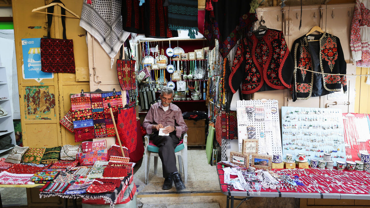 A man sits at a shop in a market near the Ibrahimi Mosque, also known as the Cave of Patriarchs, in the old city of Hebron, in the Israeli-occupied West Bank, June 17, 2026. REUTERS/Ammar Awad