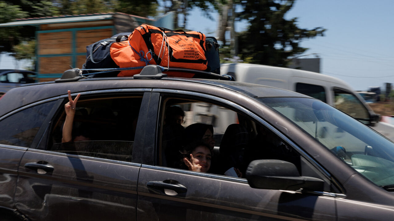 A family drives with belongings loaded on top of their car, fleeing southern Lebanon again, heading North after returning following the U.S.-Iran deal, as overnight fighting between Israeli forces and Hezbollah resumes, on the outskirts of Tyre, in southern Lebanon June 19, 2026.REUTERS/Zohra Bensemra