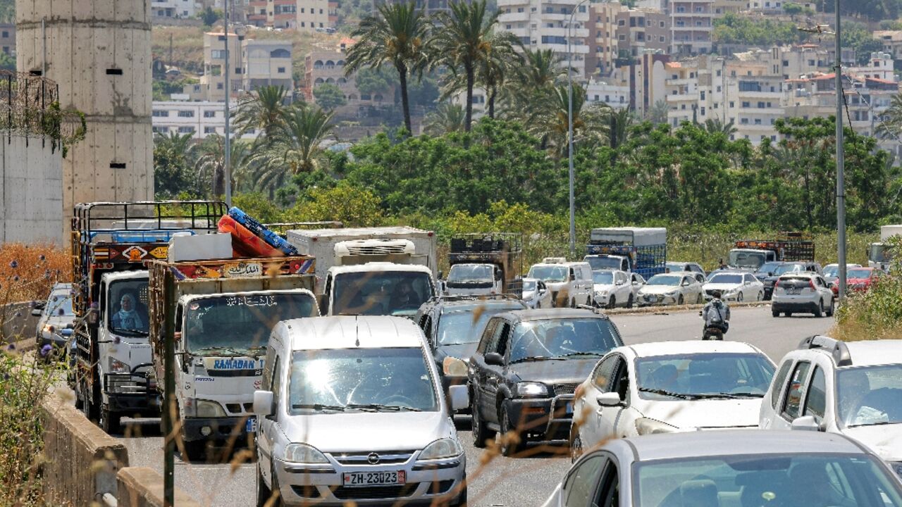 Vehicles wait in traffic as people flee Tyre in southern Lebanon after an Israeli evacuation warning