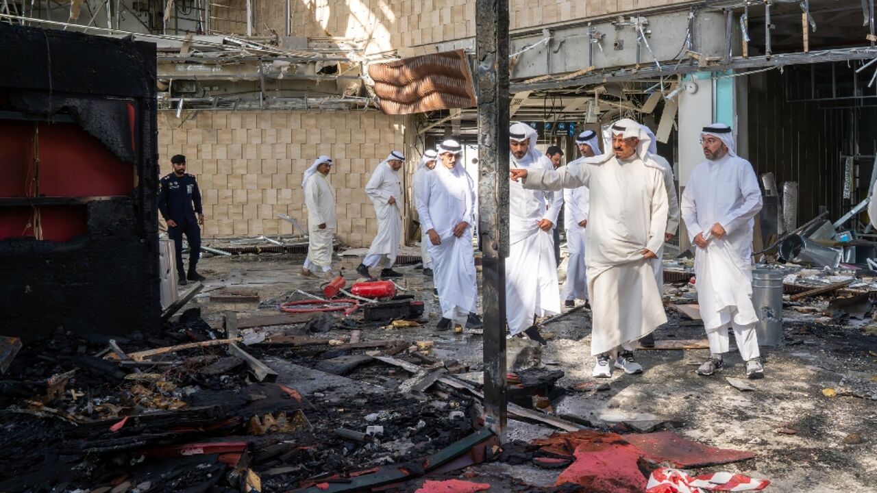 This handout photo from the Kuwaiti News Agency shows Kuwaiti Prime Minister Sheikh Ahmad al-Abdullah al-Sabah (2R) inspecting damage from an Iranian drone attack on the Kuwait City airport