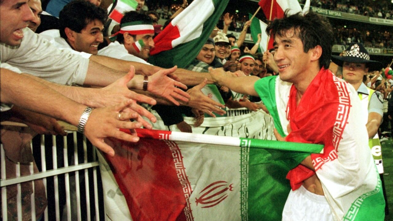 Khodadad Azizi celebrating with fans after Iran qualified for the 1998 World Cup
