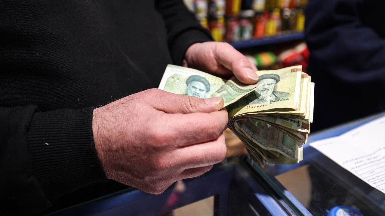 A shop owner counts Iranian banknotes at a store in the capital Tehran on Jan. 7, 2026.
