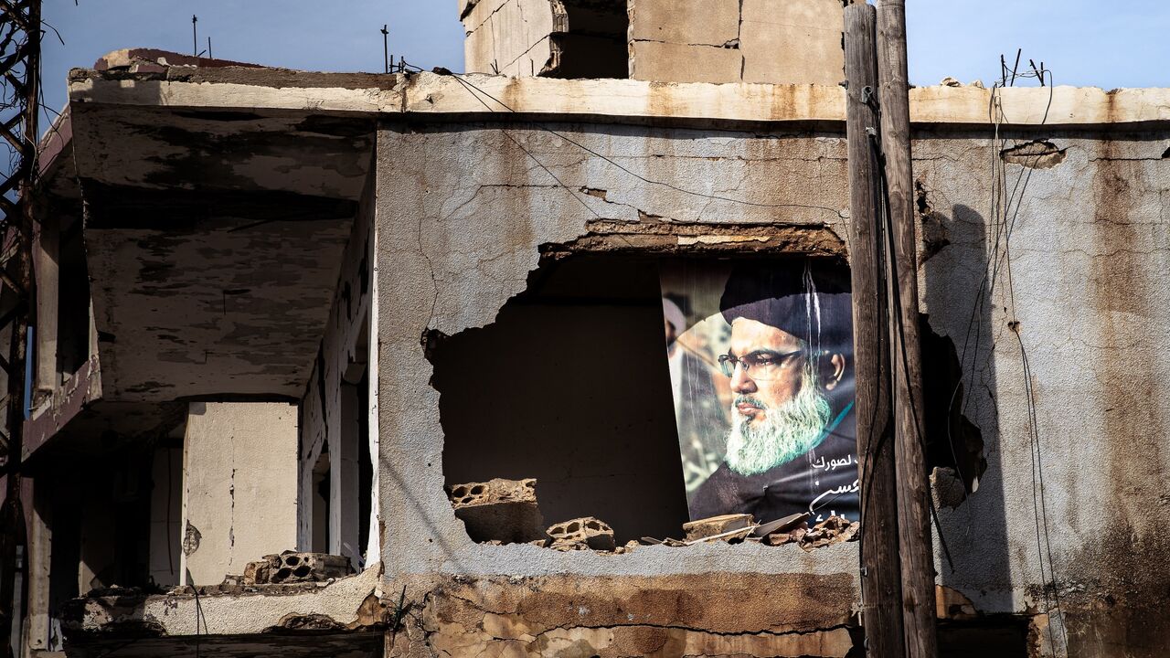 A portrait of the late Hezbollah leader Hassan Nasrallah is visible in heavily damaged building in the border town of Ayta al-Chaab, southern Lebanon, Feb. 21, 2026. 