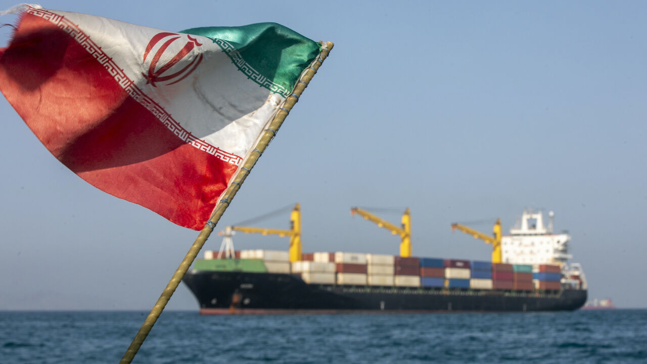 An Iranian flag flutters in the wind as ships remain anchored on May 16, 2026 in the Strait of Hormuz near Larak Island, Iran.  