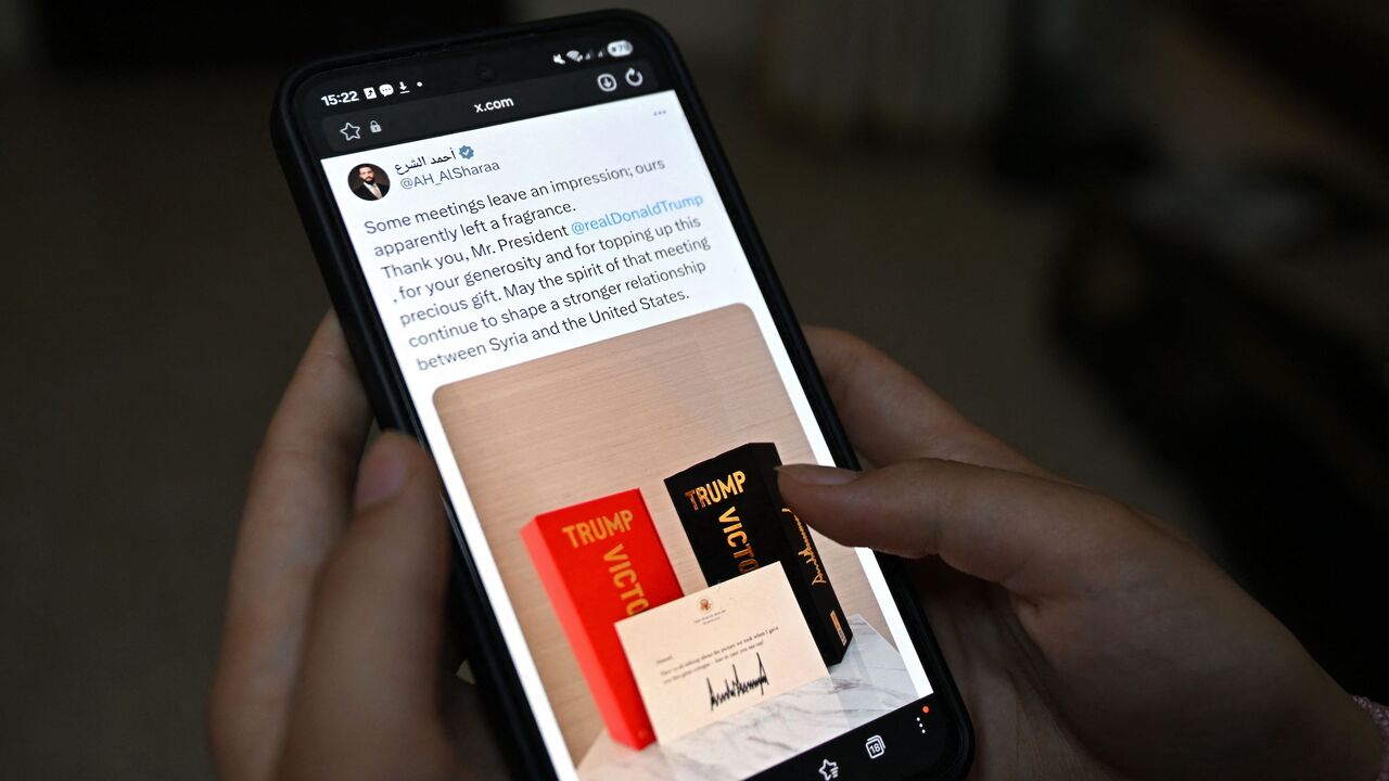 This photo illustration taken in Damascus on May 20, 2026, shows the X account of Syrian President Ahmed al-Sharaa on a smartphone displaying his tweet to President Donald Trump. 