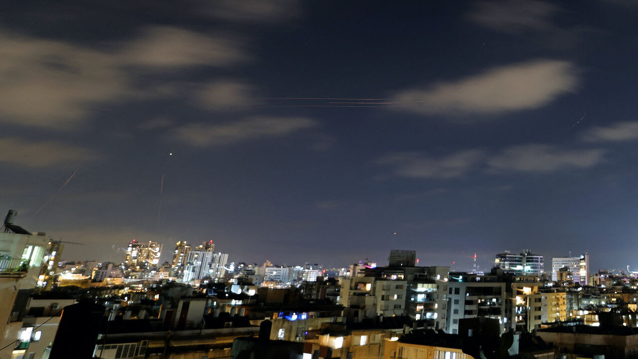 Rocket trails are seen in the sky above the Israeli coastal city of Netanya on June 7, 2026.