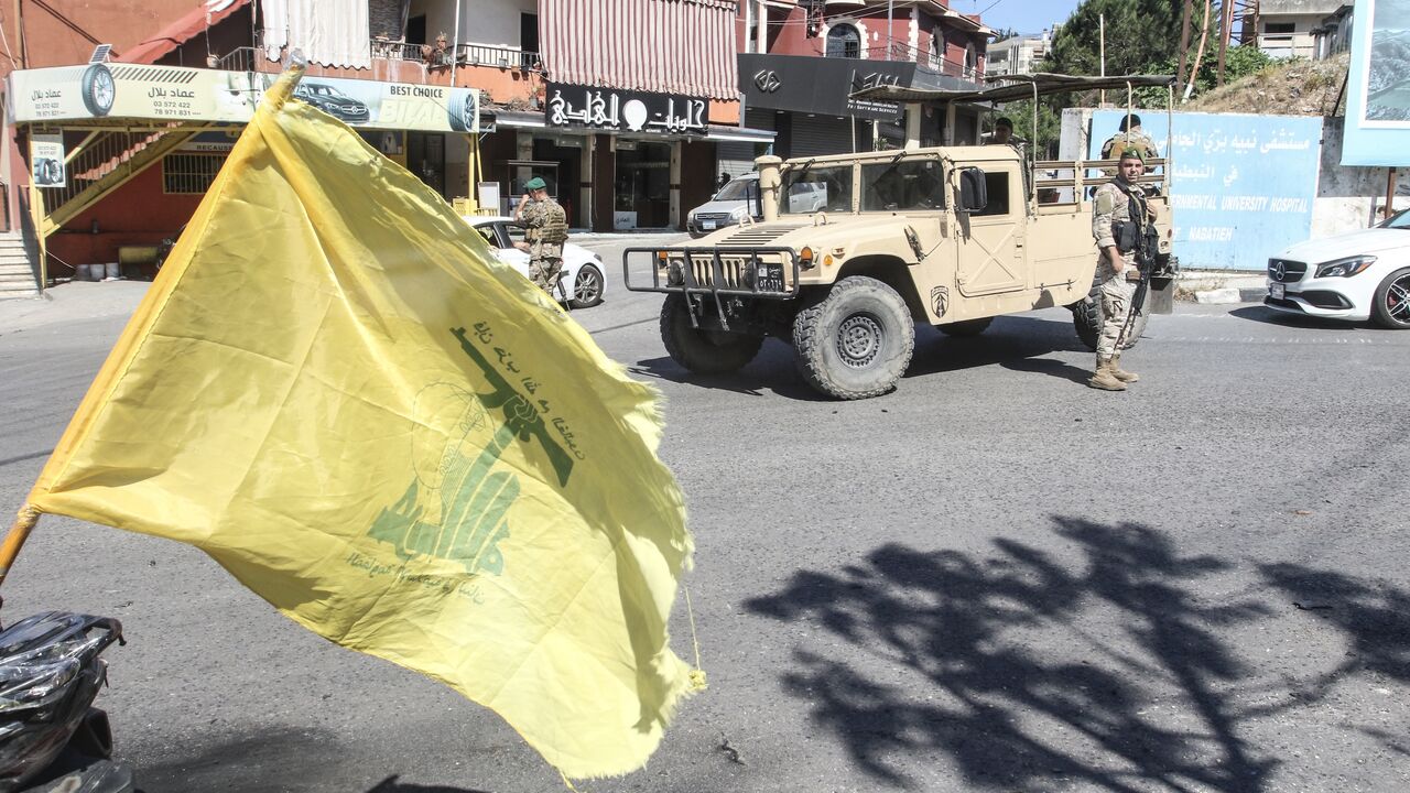 Lebanese soldiers man a check point beside a Hezbollah flag at the entrance to Nabatieh on June 15, 2026.