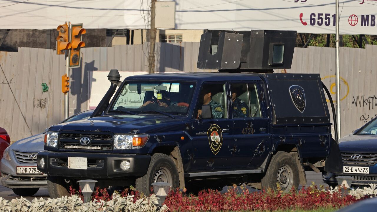 aqi security personnel patrol in a vehicle along a street in Baghdad on June 28, 2026.