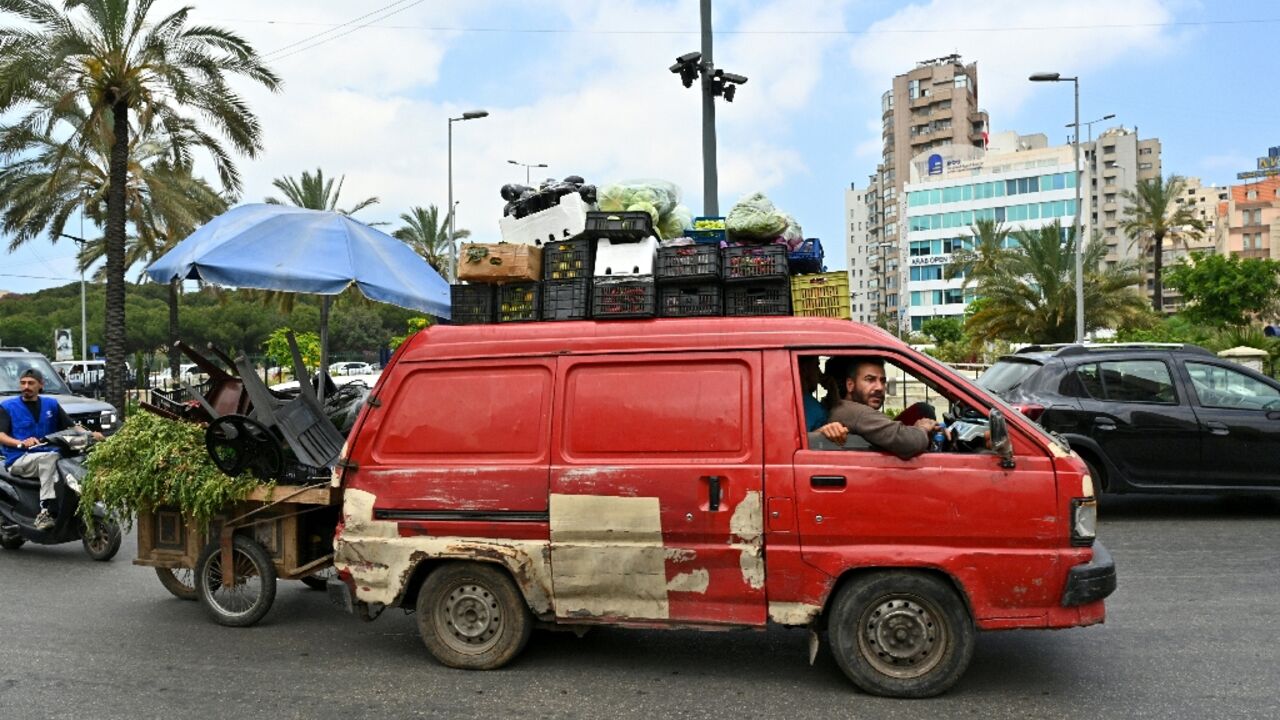 A street vendor flees with other residents after Israel ordered attacks on Beirut's southern suburbs
