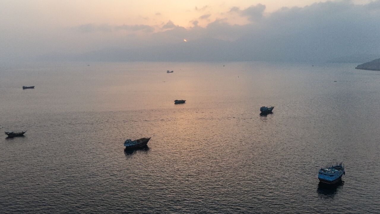 This aerial photograph shows boats anchored off Oman's northern Musandam Peninsula near the Strait of Hormuz on June 27, 2026