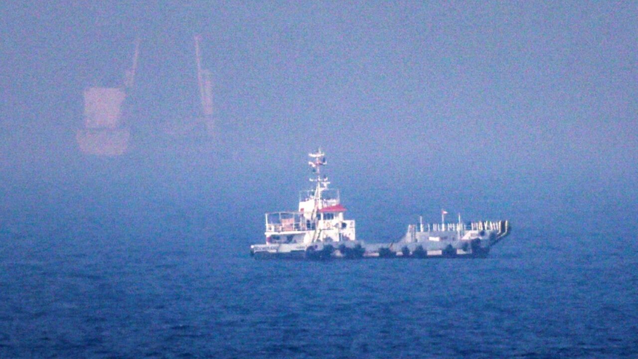 Ships sail near the Strait of Hormuz off the eastern coast of the United Arab Emirates at Khor Fakkan on July 13, 2026