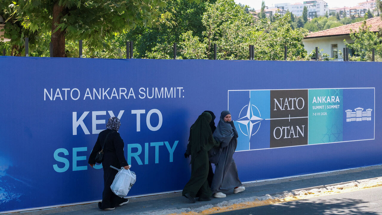 People walk past billboards built for upcoming NATO summit in Ankara, Turkey, July 1, 2026. REUTERS/Efekan Akyuz
