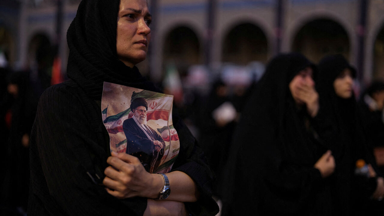 A mourner holds a portrait of late Supreme Leader Ayatollah Ali Khamenei, who was killed on February 28 in Israeli and U.S. airstrikes,  during a public farewell ceremony to pay their respects, at the Imam Khomeini Grand Mosalla, in Tehran, Iran July 4, 2026. REUTERS/Mohammed Salem Foreign media in Iran operate under guidelines set by the Ministry of Culture and Islamic Guidance, which regulates press activity and permissions