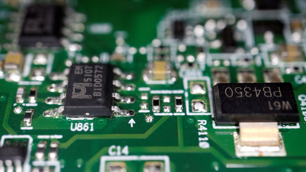 Semiconductor chips are seen on a printed circuit board in this illustration picture taken February 17, 2023. REUTERS/Florence Lo/Illustration/File Photo