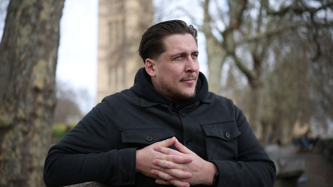 FILE PHOTO: Joe Bennett, son of British citizen Lindsay Foreman, who has been imprisoned in Iran and sentenced for 10 years with her husband Craig, following their arrest on espionage charges during a round-the-world motorcycle trip in January 2025, poses for a photograph during an interview with Reuters in London, Britain March 3, 2026. REUTERS/Isabel Infantes/File Photo