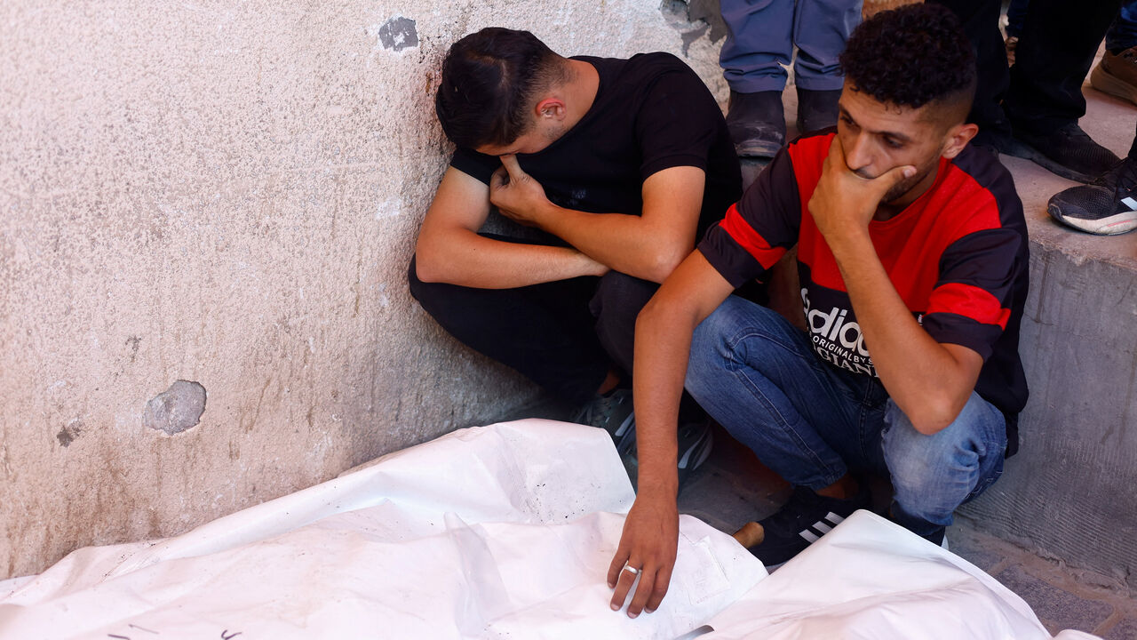 Mourners attend the funeral of Palestinian man Omar Abu Qassem, his wife Asma, and their daughter Habeeba, who were killed in an Israeli strike on Wednesday, at Al-Aqsa Martyrs hospital in Deir Al-Balah, in the central Gaza Strip, July 15, 2026. REUTERS/Mahmoud Issa