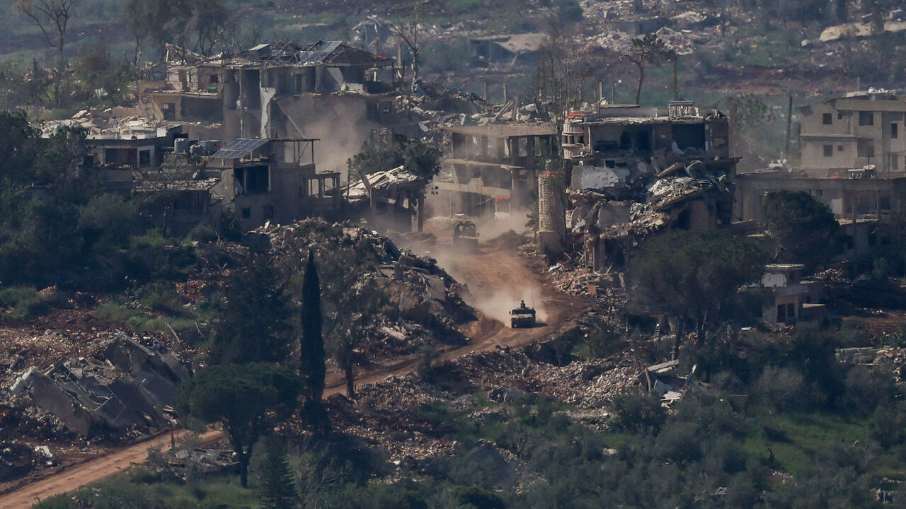 FILE PHOTO: An Israeli military vehicle drives past destroyed buildings in Lebanon, as seen from the Israeli side of the Israel-Lebanon border, April 30, 2026. REUTERS/Shir Torem/File Photo