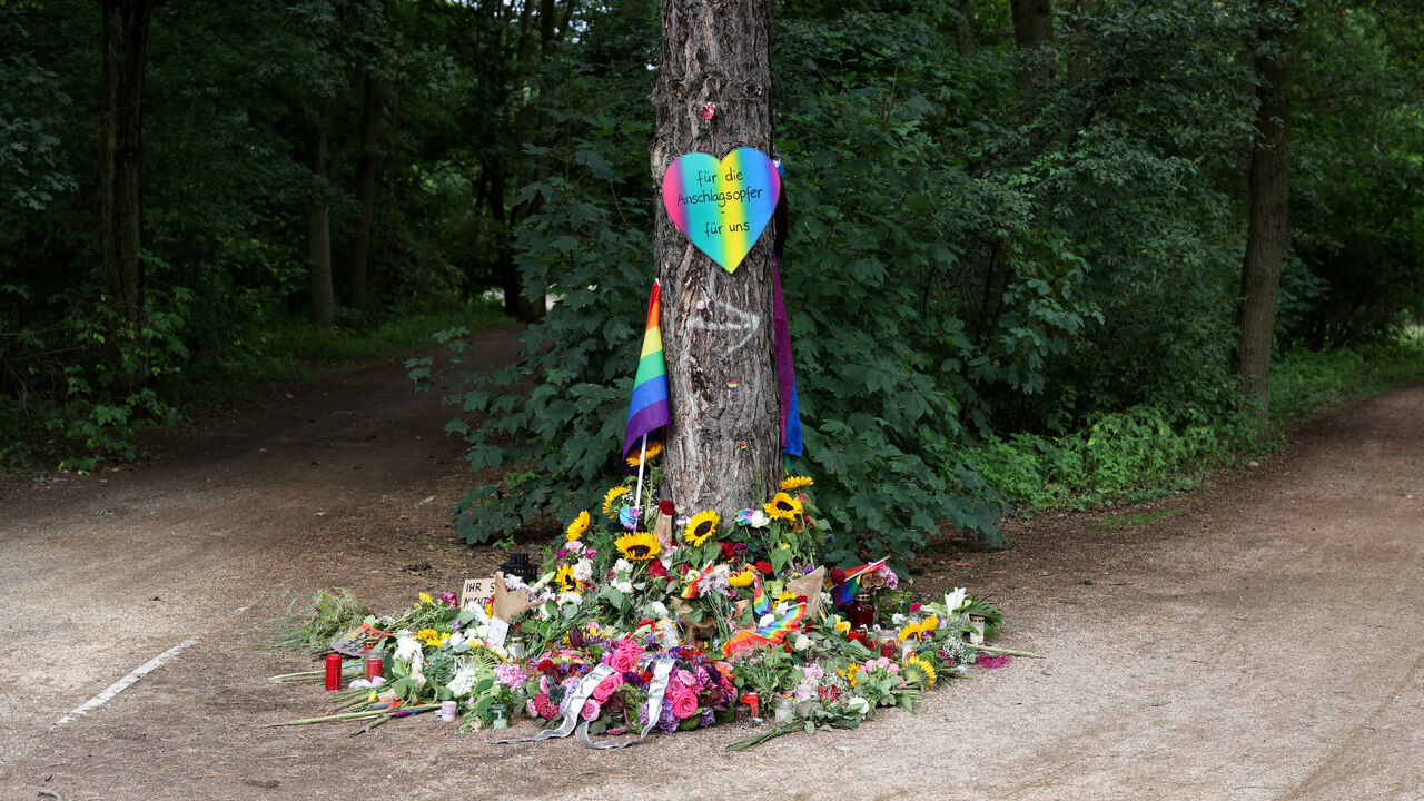 A view of a makeshift memorial at Tiergarten park after a deadly incident in which a vehicle crashed into a crowd near Berlin's annual Christopher Street Day Pride parade on Saturday evening, leaving multiple people injured and the parade called off, in Berlin, Germany, July 27, 2026. The placard reads: "We honor all the victims and survivors. We will not allow ourselves to be divided". REUTERS/Christian Mang