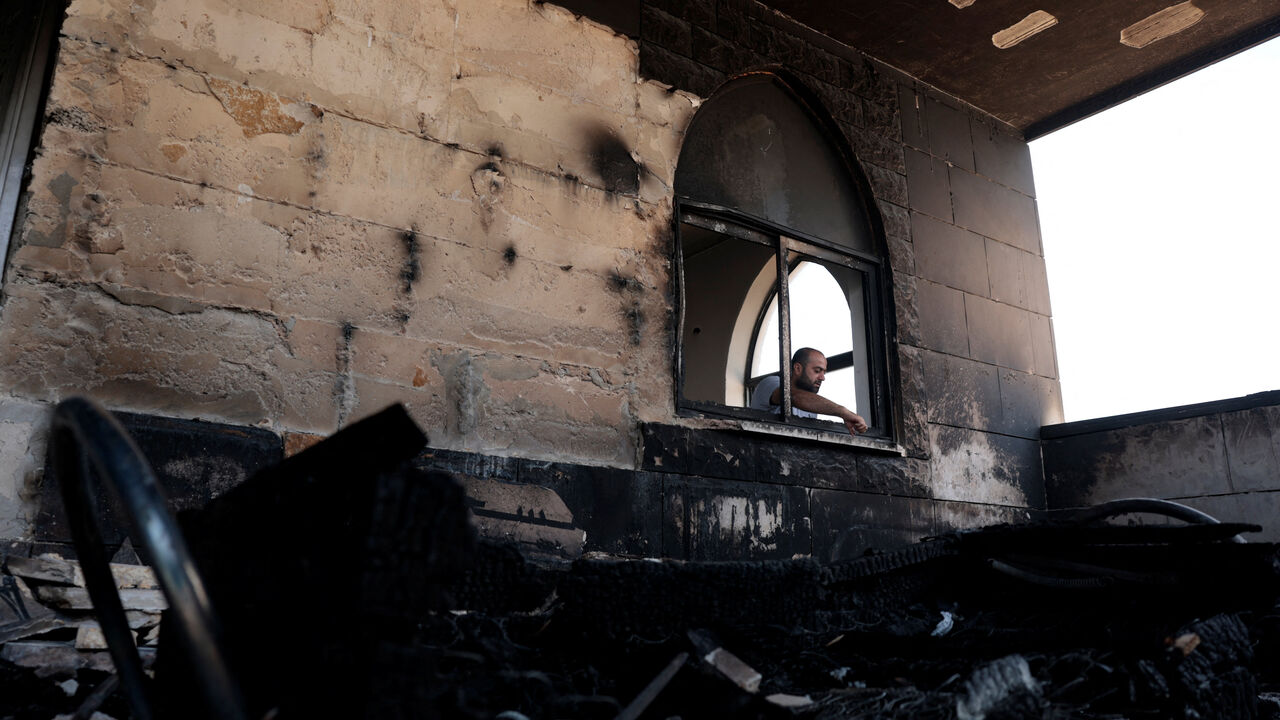 A Palestinian man inspects the damage at a mosque, which Palestinians say was damaged by Israeli settlers, in Qusra near Nablus, in the Israeli-occupied West Bank, July 26, 2026. REUTERS/Mohamad Torokman/File Photo