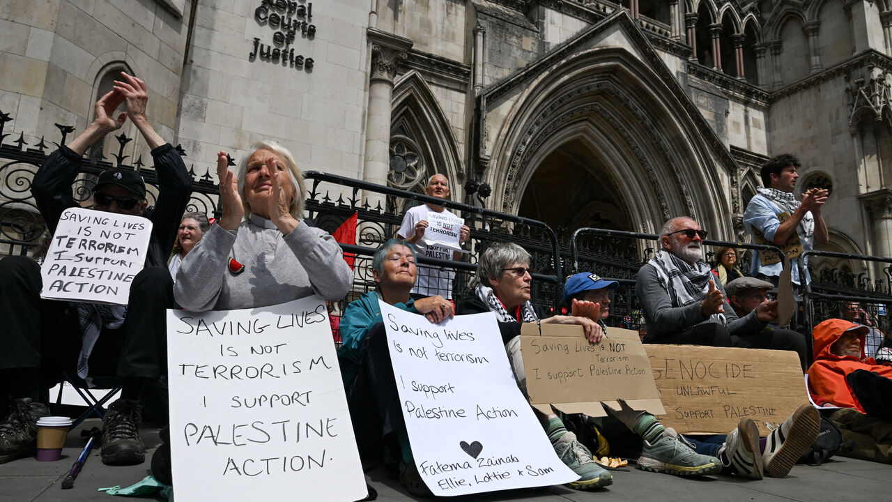 FILE PHOTO: People attend a demonstration opposing the government's decision to ban Palestine Action as a terror organisation, following a Court of Appeal ruling on the lawfulness of proscribing the pro-Palestinian group under terrorism laws, outside the Royal Courts of Justice, in London, Britain, June 15, 2026. REUTERS/Chris J. Ratcliffe/File Photo