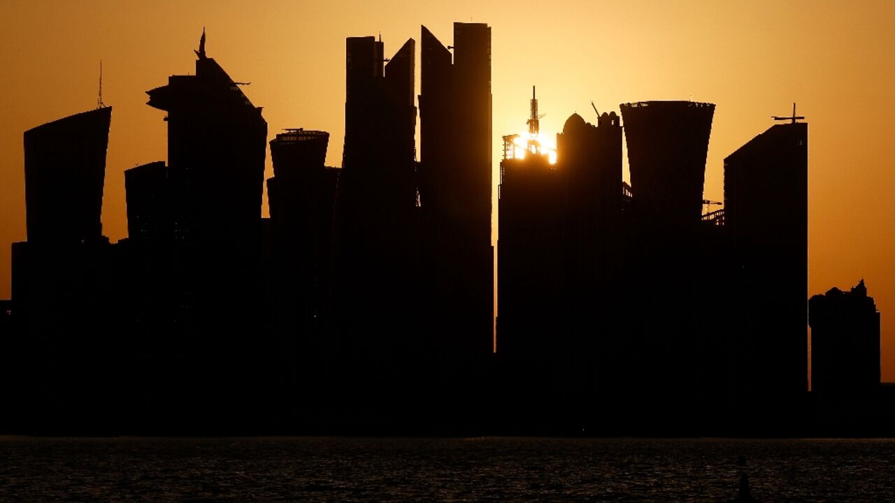 The sun sets behind the Doha skyline on June 29, 2026