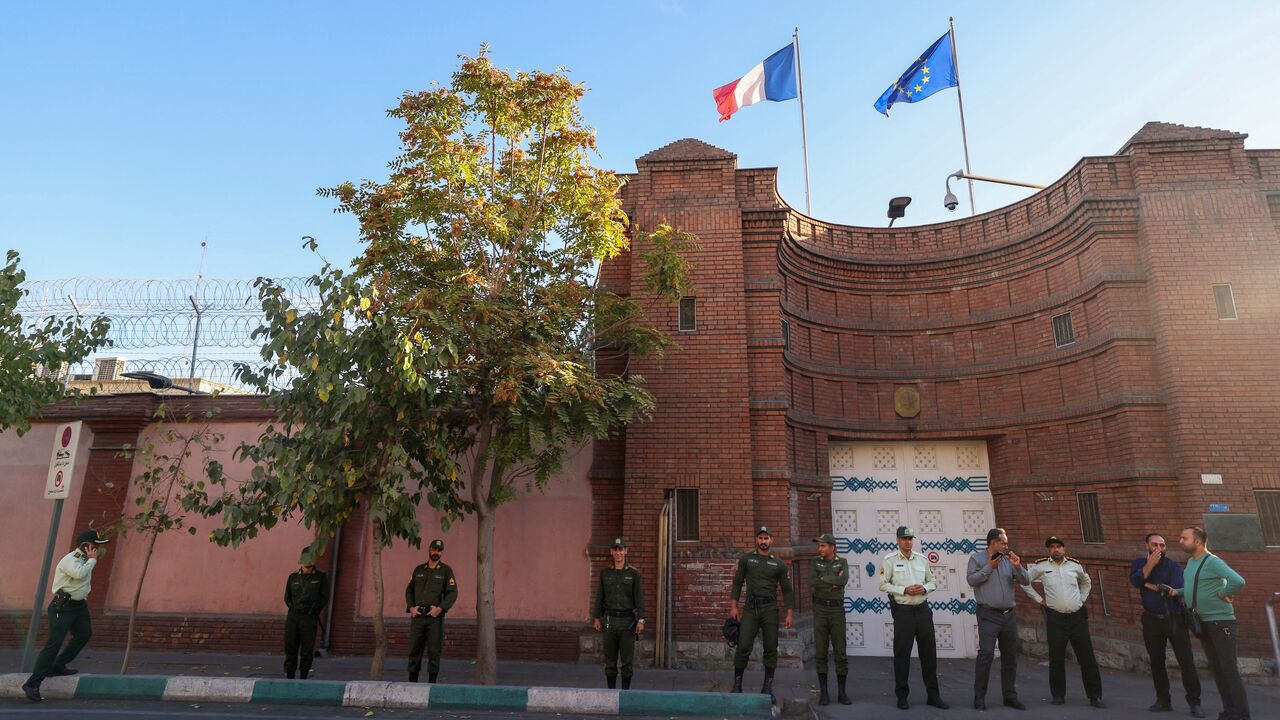 Iranian security forces stand guard in front of the French Embassy in Tehran in this undated image. 