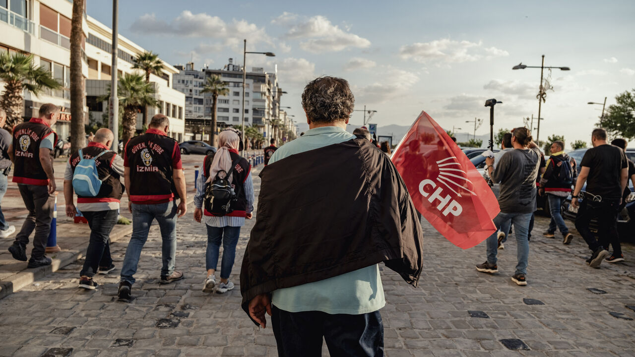 A demonstrator carries a CHP flag during a protest in Izmir, Turkey, on May 24, 2026. 