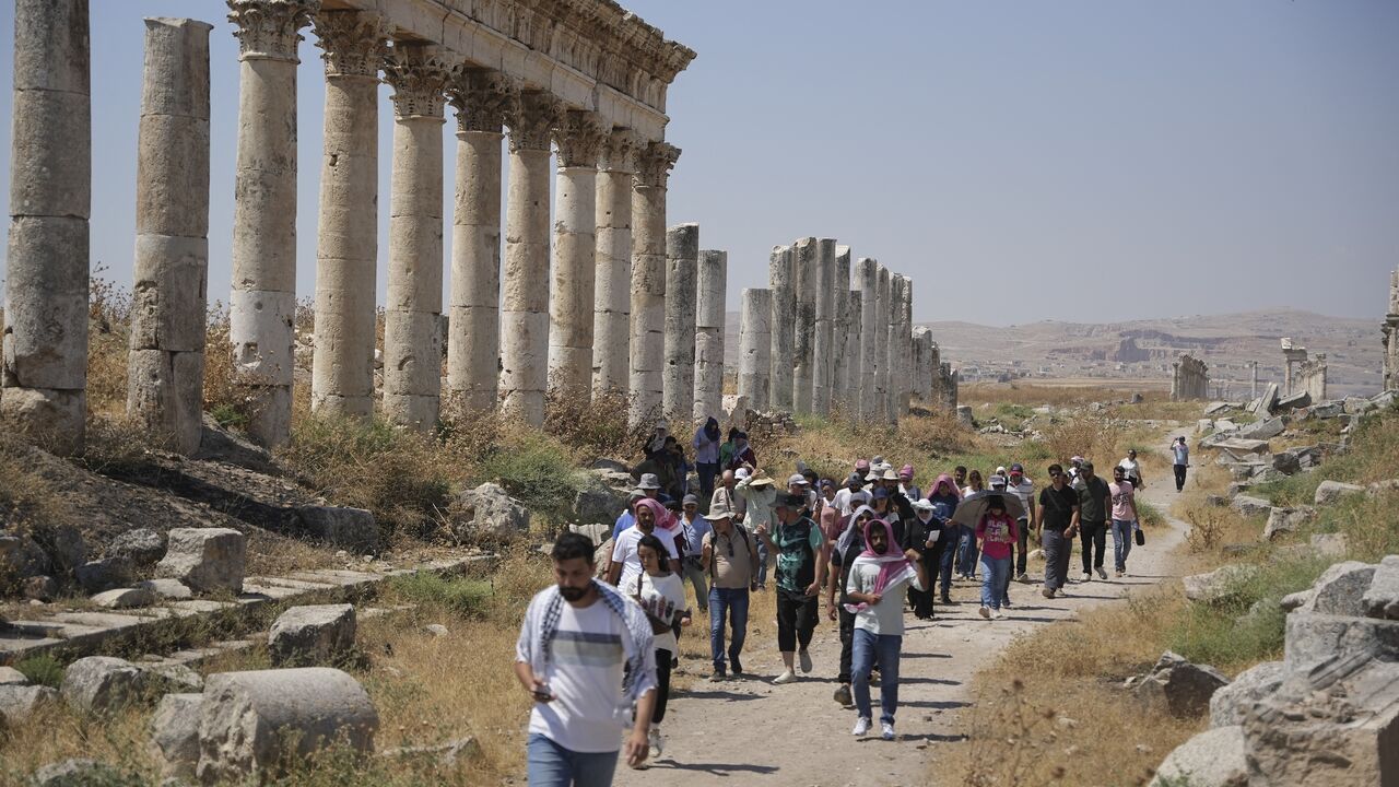 Tourism students and visitors visit the ruins of the ancient city of Apamea in the Hama countryside, Syria, on July 8, 2026. 