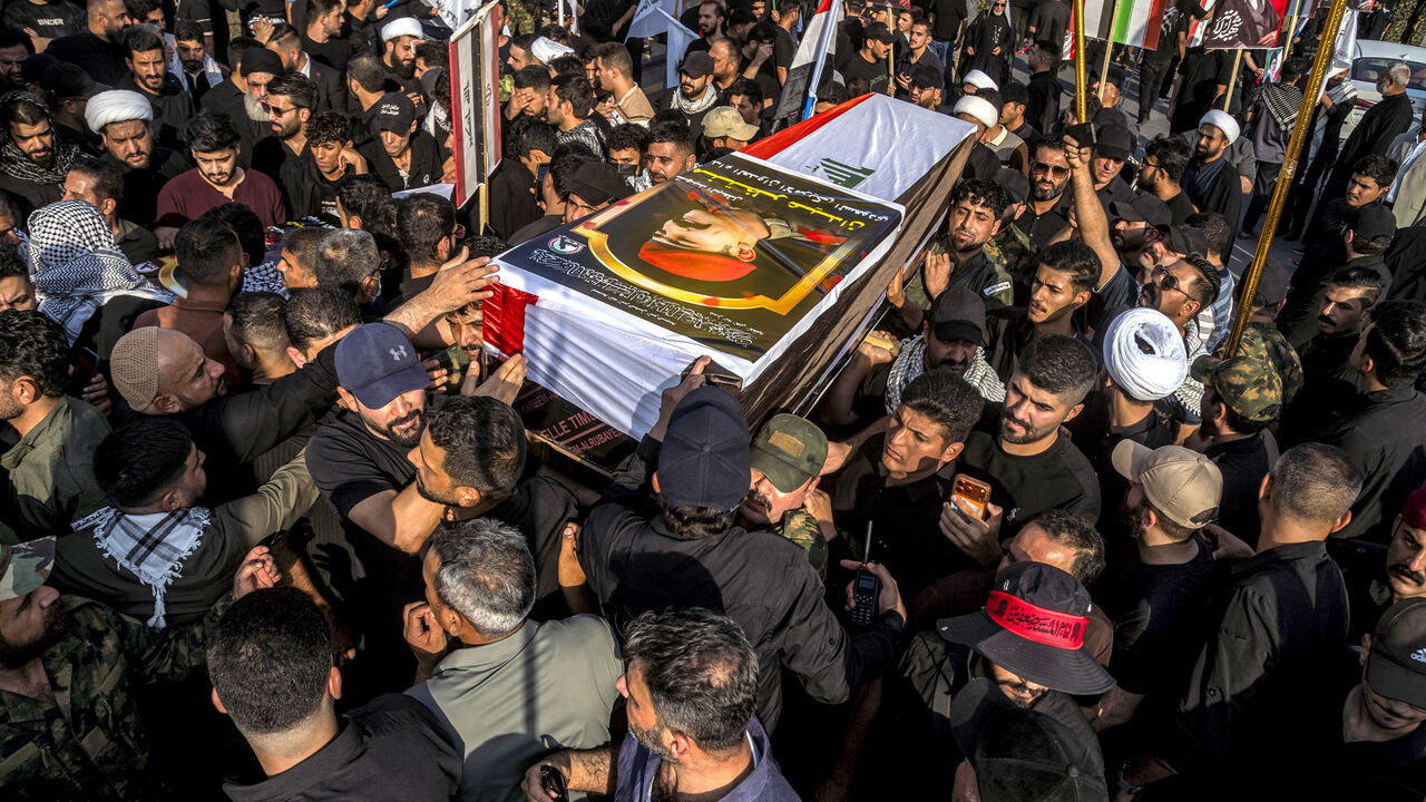 Mourners carry one of the bodies of members of Iraq's Hashed al-Shaabi, or Popular Mobilisation Forces (PMF) who were killed earlier in Diyala in central Iraq by US-Saudi strikes, during the funeral in Baghdad on July 29, 2026. The US-Saudi strikes killed at least 20 militants, including Iranians, according to the Hashed al-Shaabi. The US and Saudi Arabia said the strikes were in response to attacks on US forces and Saudi oil facilities. (Photo by murtadha ridha / AFP via Getty Images) /