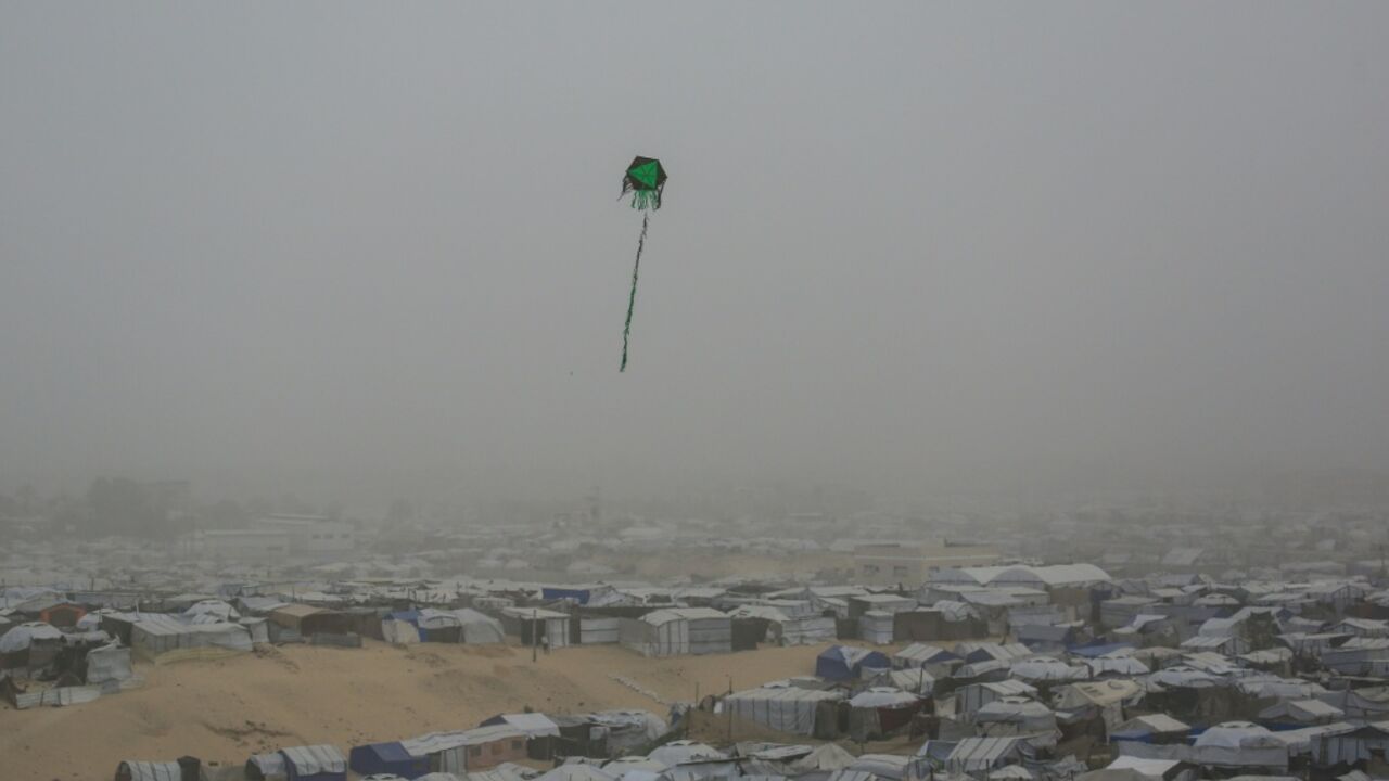 A kite flies over tents and makeshift shelters at a camp for displaced Palestinians in Khan Yunis, in the southern Gaza in February 2026
